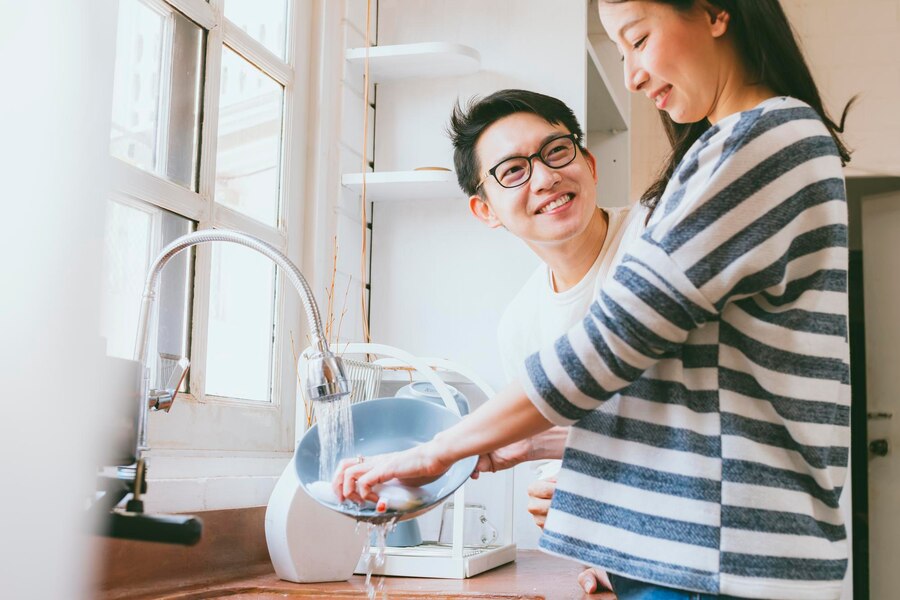 attractive couple husband wife asian family wash dishes together with smile happiness kitchen home family concept